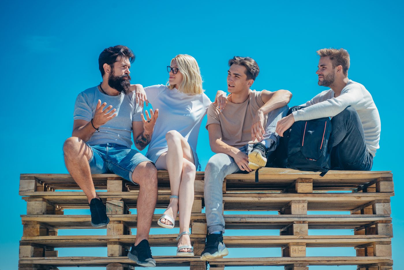 Diverse group of people sitting together, sharing a relaxed and collaborative moment